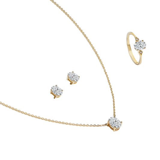 Gold jewelry set with necklace, earrings, and ring on a white background, branded 'Minty Box'.