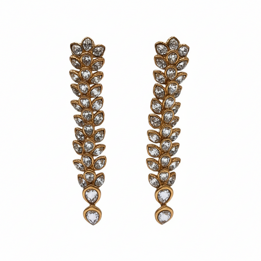 Pair of gold and crystal leaf-shaped earrings on a white background
