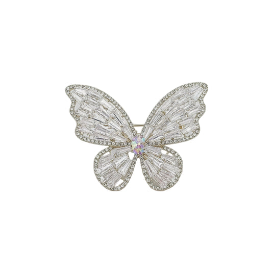 Butterfly-shaped jewelry on a card with 'Fashion Jew' branding, held against a blurred indoor background.