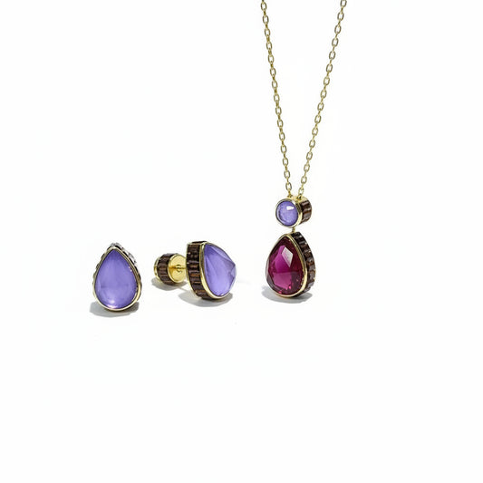 Jewelry set with purple teardrop-shaped stones on a white surface
