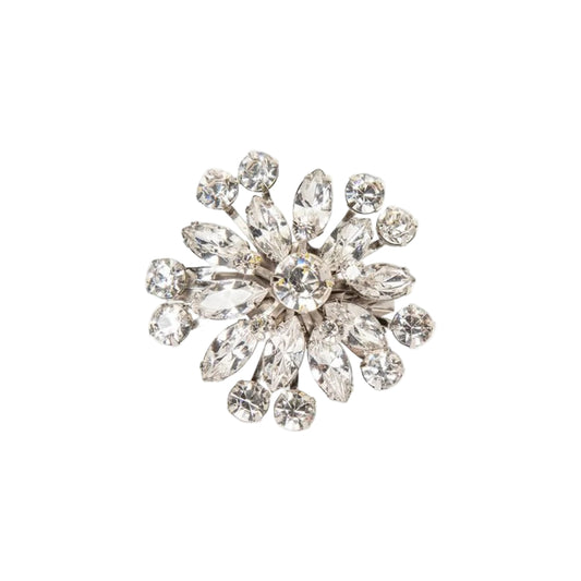 Decorative brooch with crystal-like stones on a white background